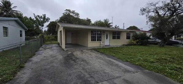 a view of a house with yard and a garden