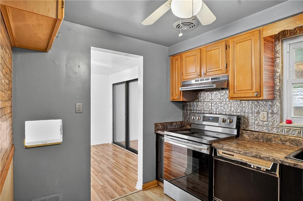 1209 Varner Road Pittsburgh, PA 15227 - Photo 12 of 40 a kitchen with stainless steel appliances granite countertop a stove sink and cabinets