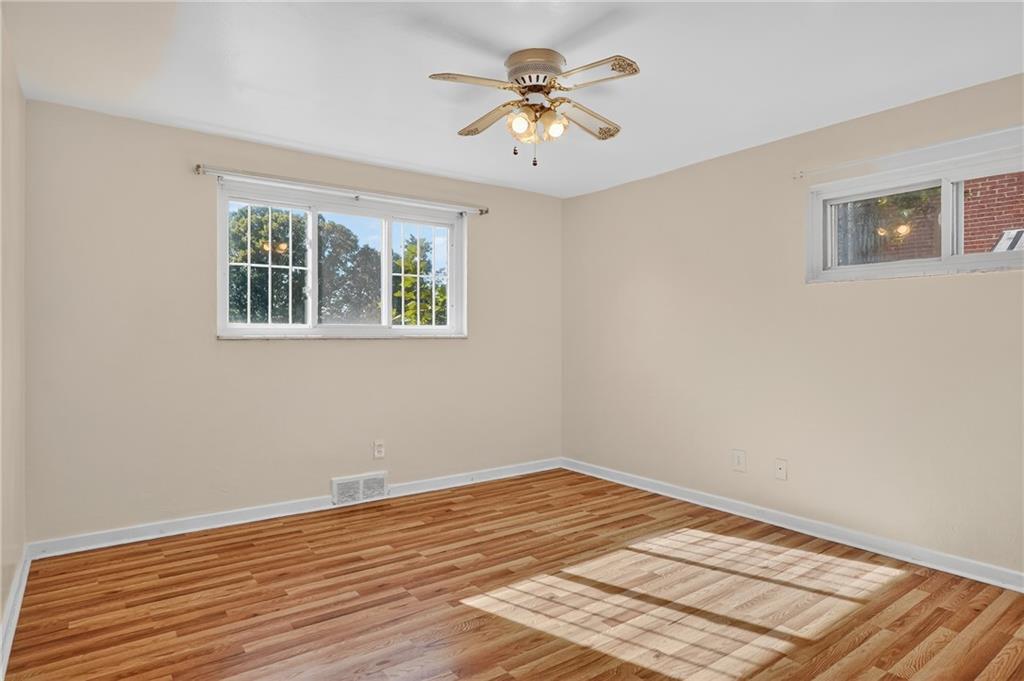 1209 Varner Road Pittsburgh, PA 15227 - Photo 19 of 40 a view of a room with wooden floor and a ceiling fan