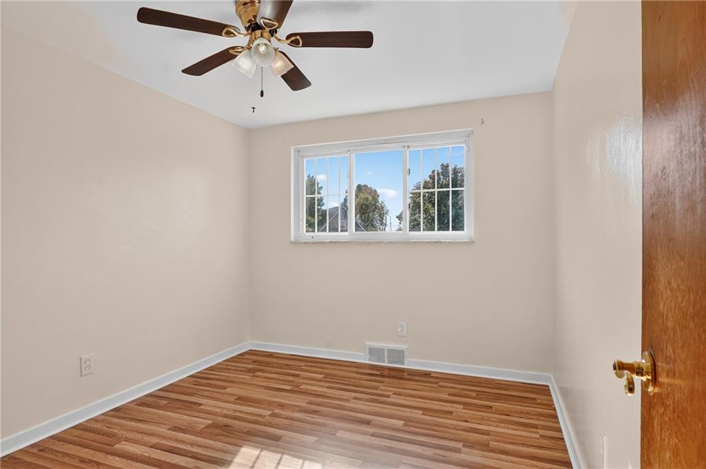 1209 Varner Road Pittsburgh, PA 15227 - Photo 21 of 40 a view of empty room with wooden floor and fan