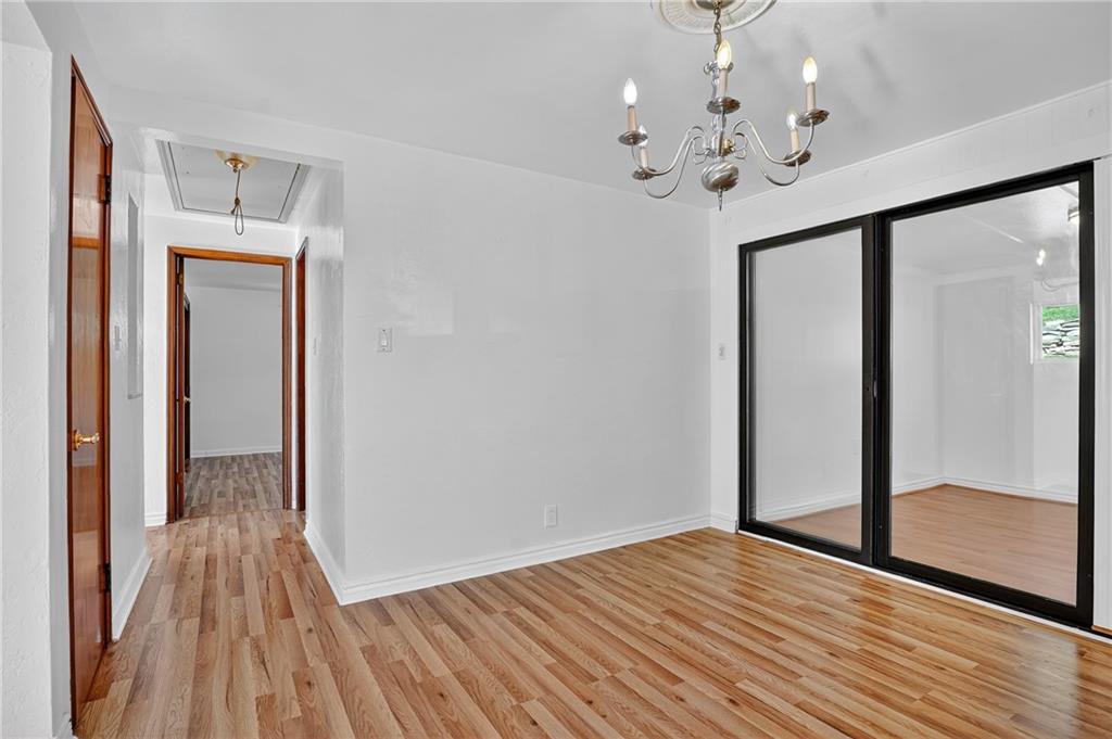 1209 Varner Road Pittsburgh, PA 15227 - Photo 25 of 40 a view of a room with wooden floor chandelier and closet