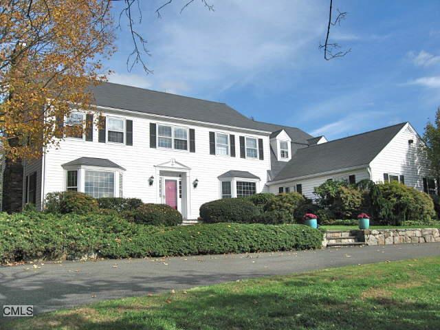 40 Hunting Ridge Lane Wilton, CT 06897 - Photo 1 of 1 a front view of a house with a yard