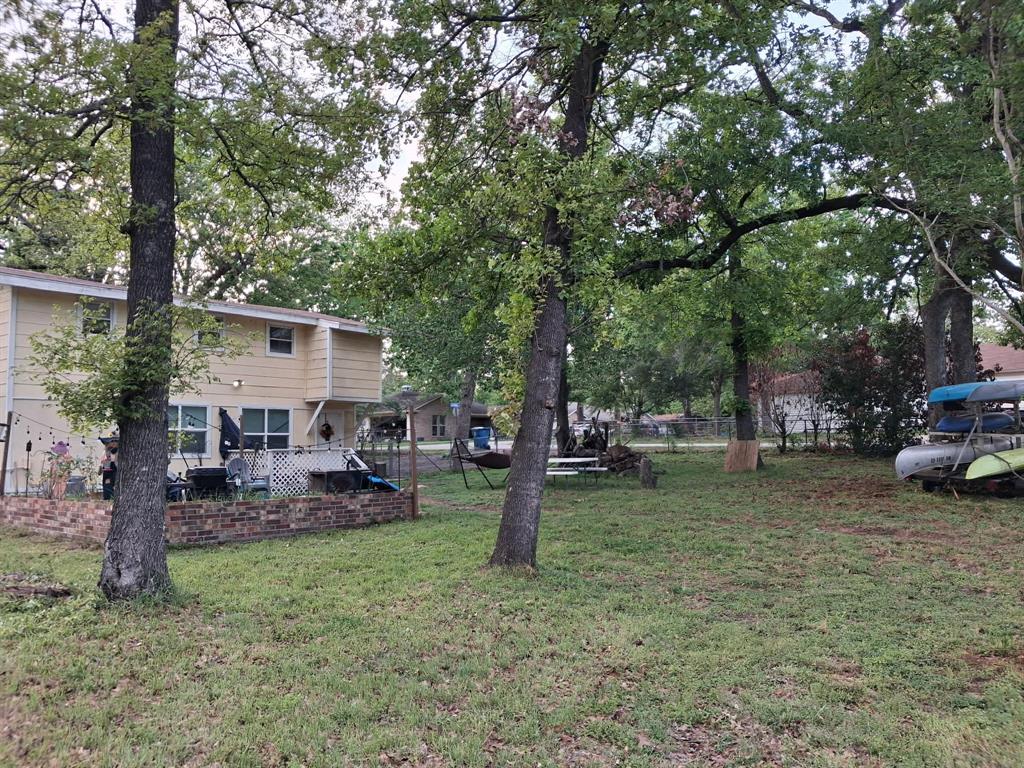 304 Ridgewood Drive Tool, TX 75143 - Photo 3 of 12 a view of a house with a backyard and trees