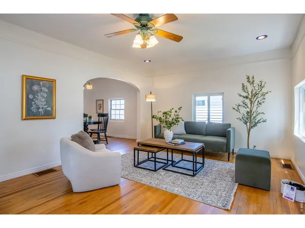a living room with furniture and a chandelier