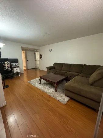 a living room with couches and a flat screen tv