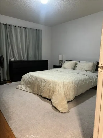 a bedroom with a bed and curtain