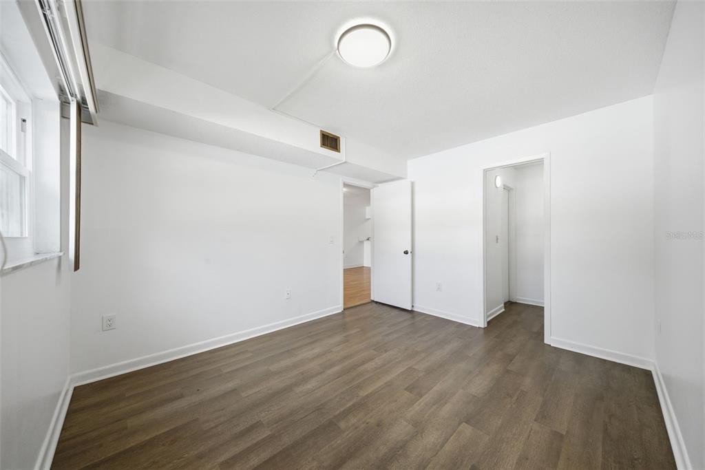141 Fernery Road, Unit A3 Lakeland, FL 33809 - Photo 15 of 40 a view of an empty room with wooden floor and a window