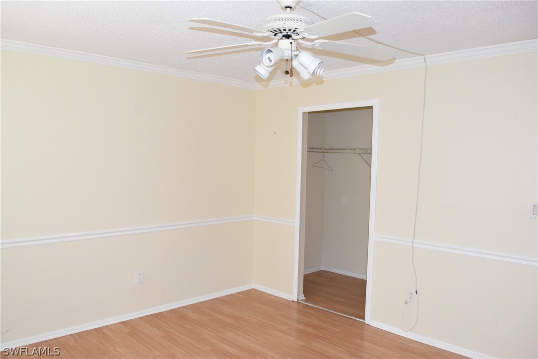 6777 Winkler Road, Unit 174 Fort Myers, FL 33919 - Photo 9 of 19 an empty room with wooden floor and fan