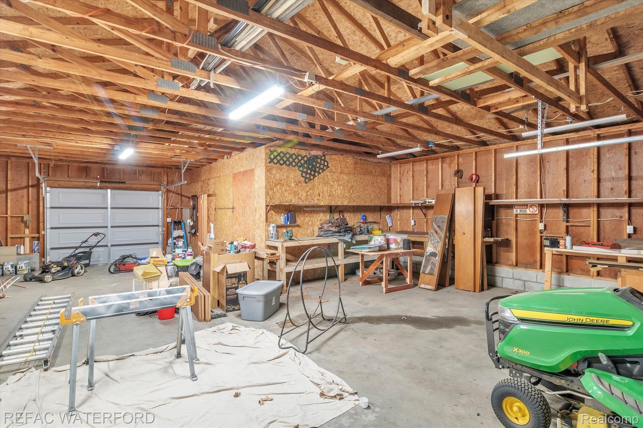 480 Roscommon Road Roscommon, MI 48653 - Photo 38 of 65 Great workbench area in drive-thru garage. SO MUCH SPACE! And wonderful lighting to work on equipment!