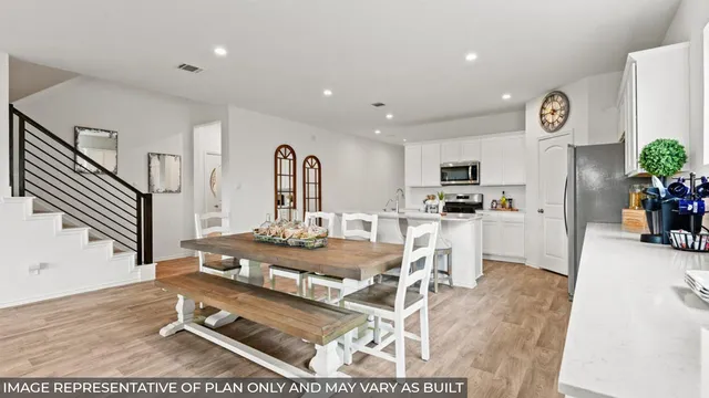 a room with stainless steel appliances kitchen island granite countertop furniture and a view of kitchen