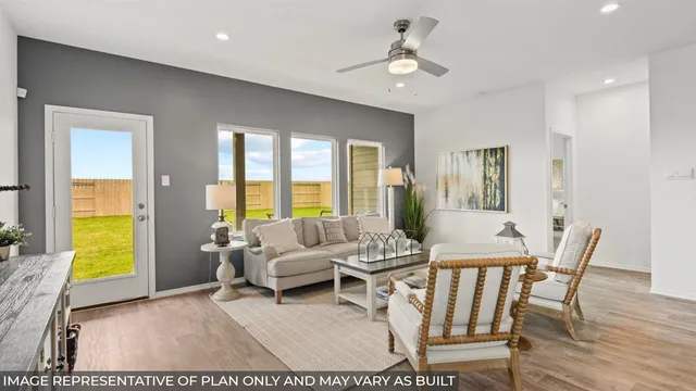 a living room with furniture a fireplace and a large window