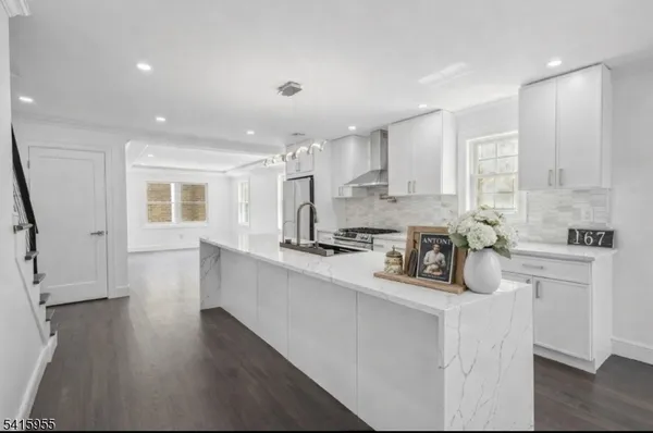 a kitchen with a sink cabinets and wooden floor