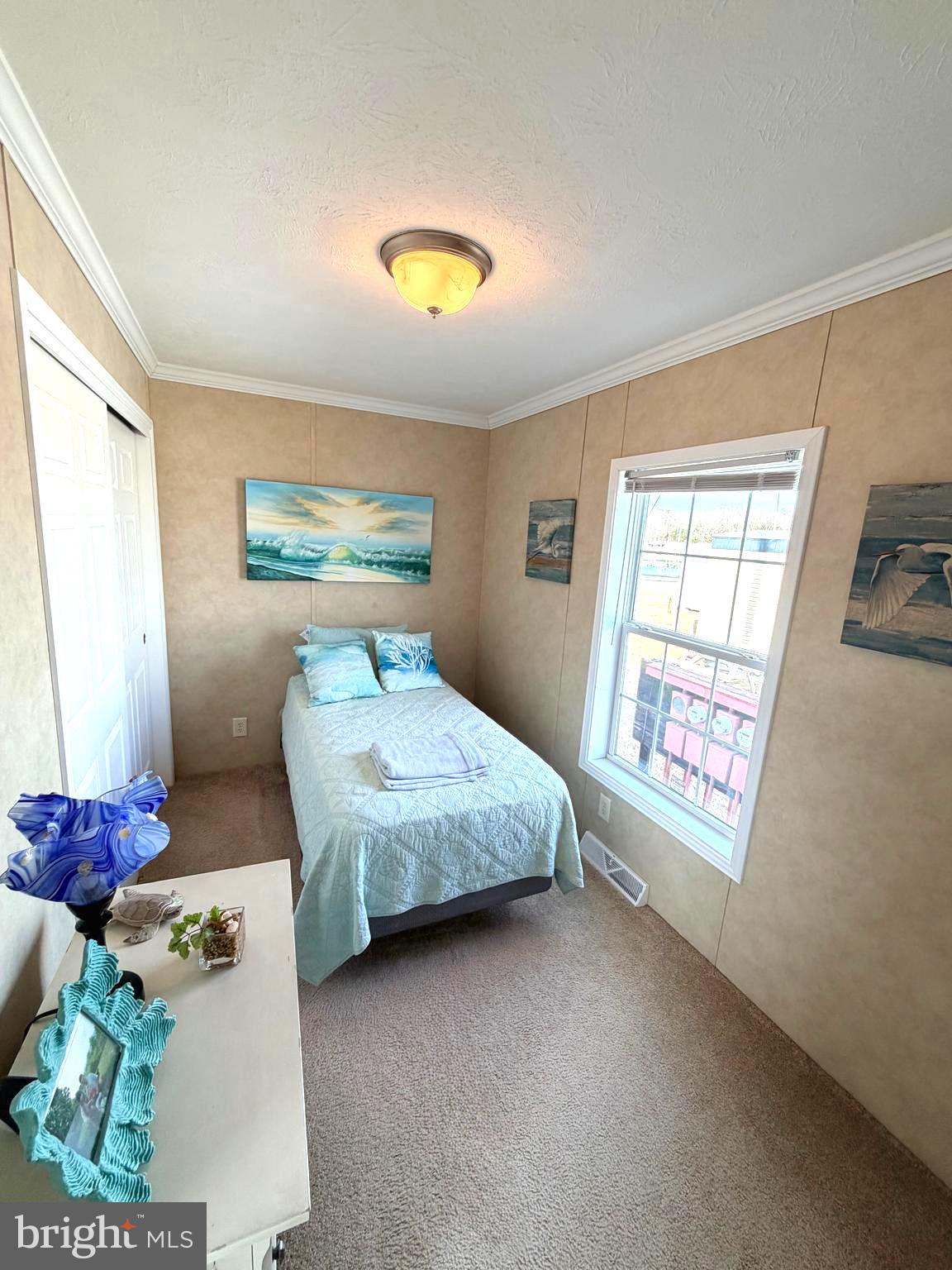 38025 Rabbit Road, Unit 101 Ocean View, DE 19970 - Photo 61 of 112 a bedroom with a bed and a window