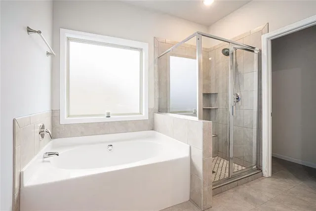 a white bath tub sitting next to a shower