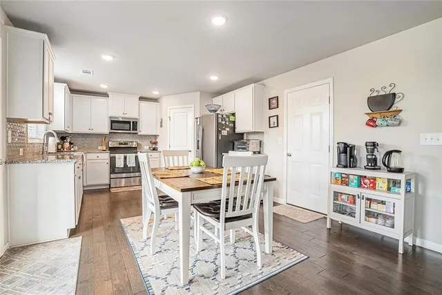 a view of kitchen with cabinets table and chairs