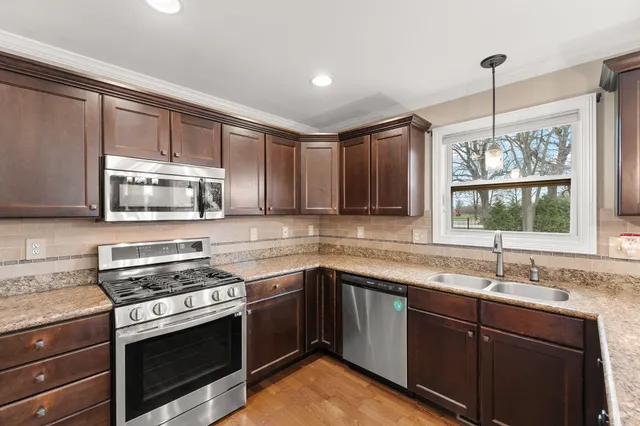 a kitchen with a sink stove and microwave