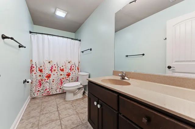 a bathroom with a sink a vanity and a toilet