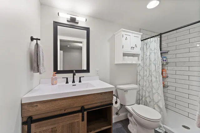 a bathroom with a sink toilet and shower