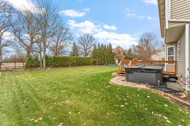 a backyard of a house with table and chairs