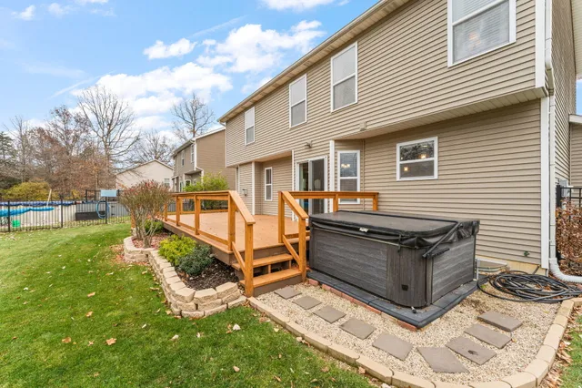 a view of a house with backyard and sitting area