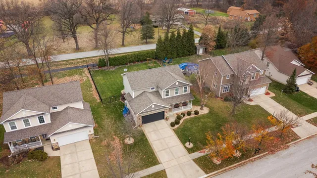 an aerial view of a house with garden space and street view
