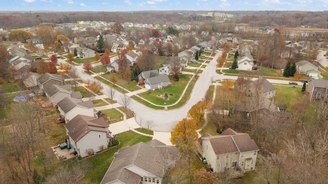 an aerial view of residential houses with outdoor space