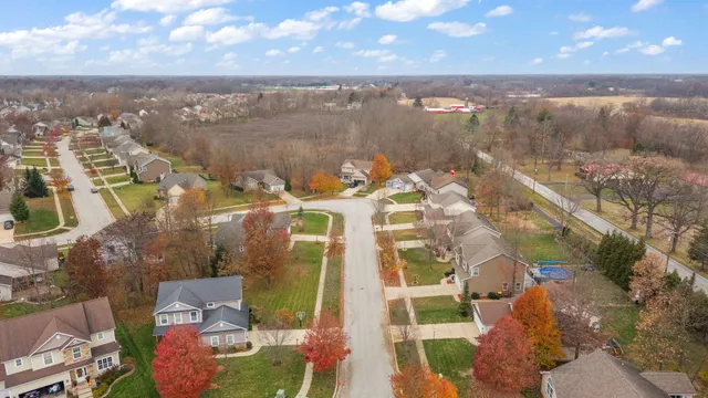 a front view of a house with yard and green space