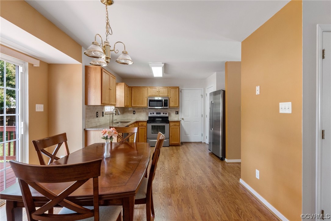 6708 Gills Gate Court Chesterfield, VA 23832 - Photo 11 of 34 a view of a dining room and livingroom with furniture wooden floor a chandelier