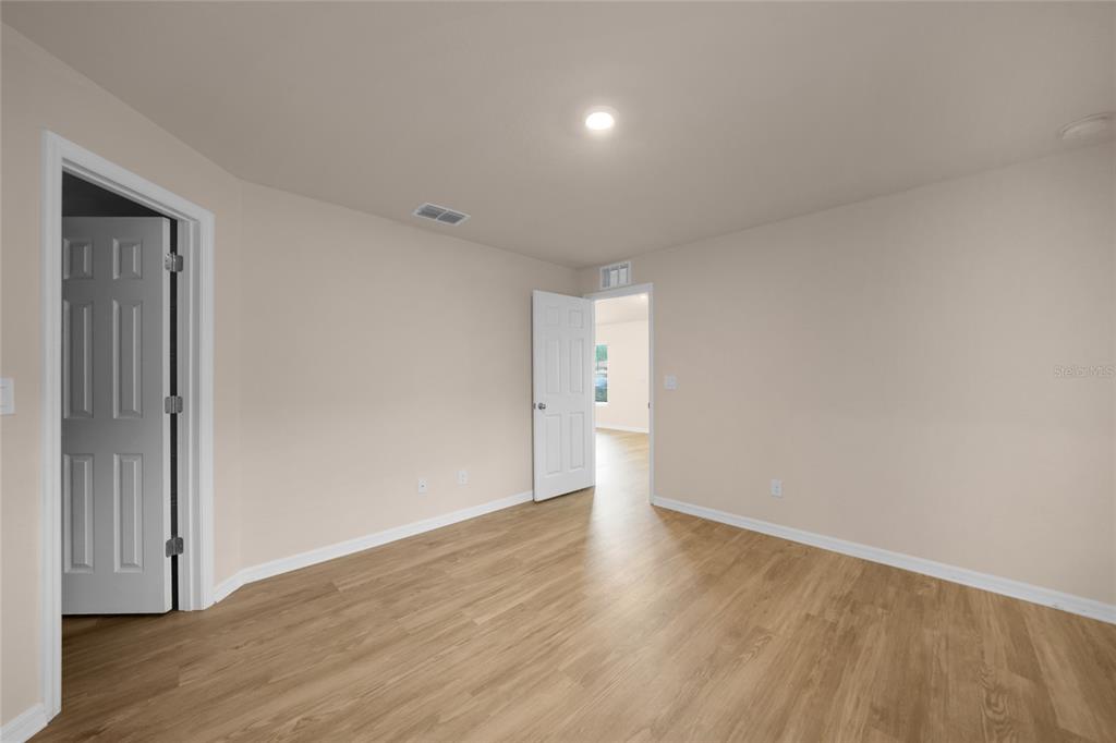 11057 Pendleton Avenue Englewood, FL 34224 - Photo 11 of 37 a view of an empty room with wooden floor