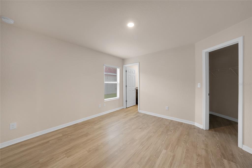 11057 Pendleton Avenue Englewood, FL 34224 - Photo 12 of 37 an empty room with wooden floor and windows