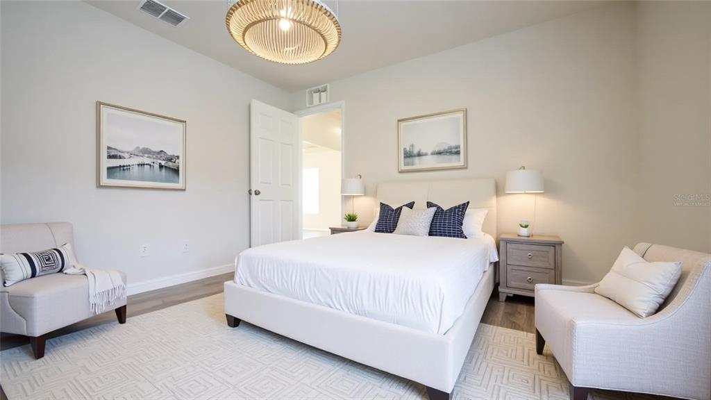 11057 Pendleton Avenue Englewood, FL 34224 - Photo 13 of 37 a bedroom with bed and a couch