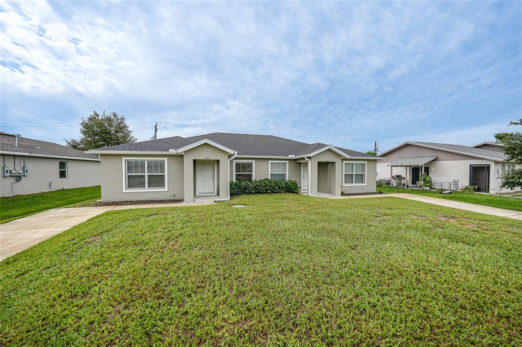 11057 Pendleton Avenue Englewood, FL 34224 - Photo 25 of 37 a front view of house with yard and green space