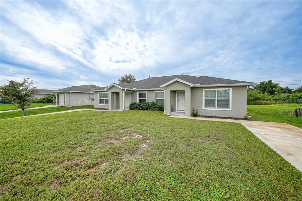 11057 Pendleton Avenue Englewood, FL 34224 - Photo 27 of 37 a front view of house with yard and green space