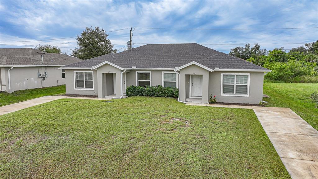 11057 Pendleton Avenue Englewood, FL 34224 - Photo 29 of 37 front view of a house and a yard