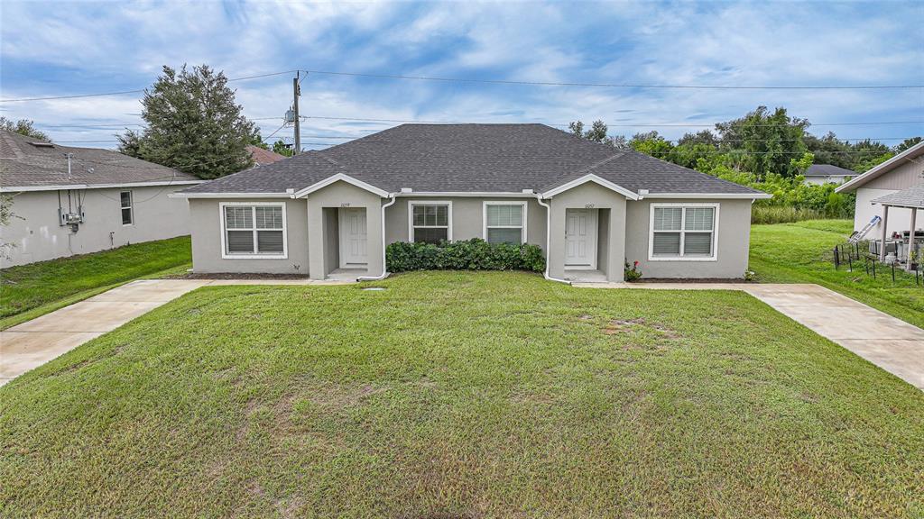 11057 Pendleton Avenue Englewood, FL 34224 - Photo 31 of 37 front view of a house and a yard