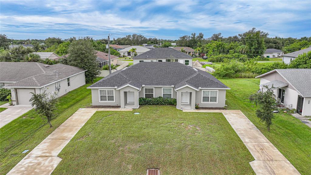 11057 Pendleton Avenue Englewood, FL 34224 - Photo 32 of 37 an aerial view of house with yard