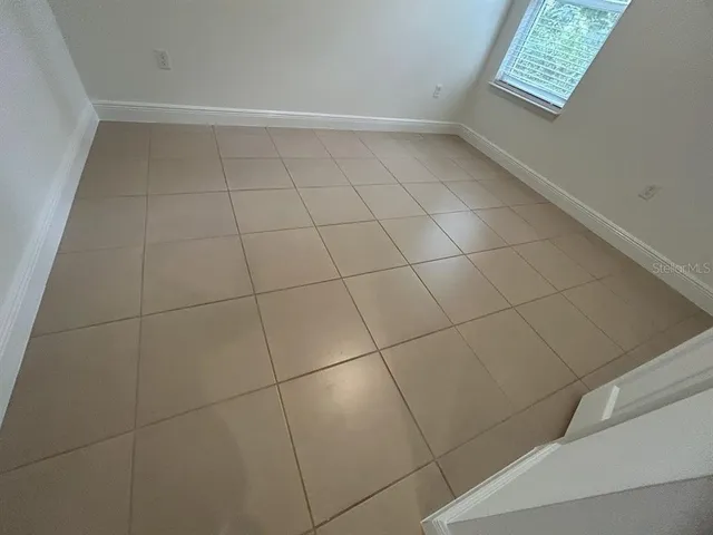 a view of an empty room and a window