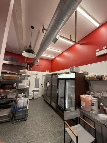 a storage room with stove and chairs