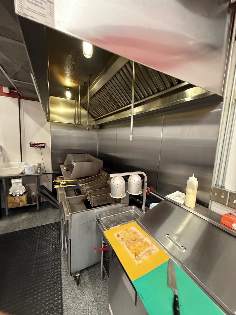 3602 West 16th Street Chicago, IL 60623 - Photo 5 of 10 a storage room with stove and chairs