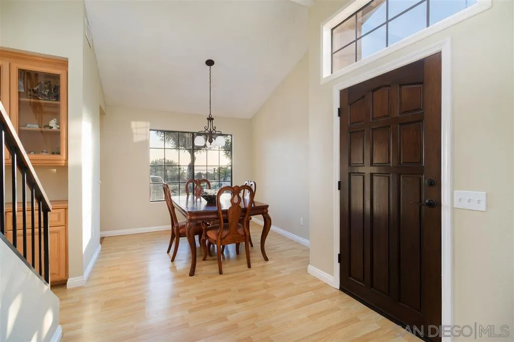 13524 Ridley Road San Diego, CA 92129 - Photo 8 of 23 a dining room with furniture window and wooden floor