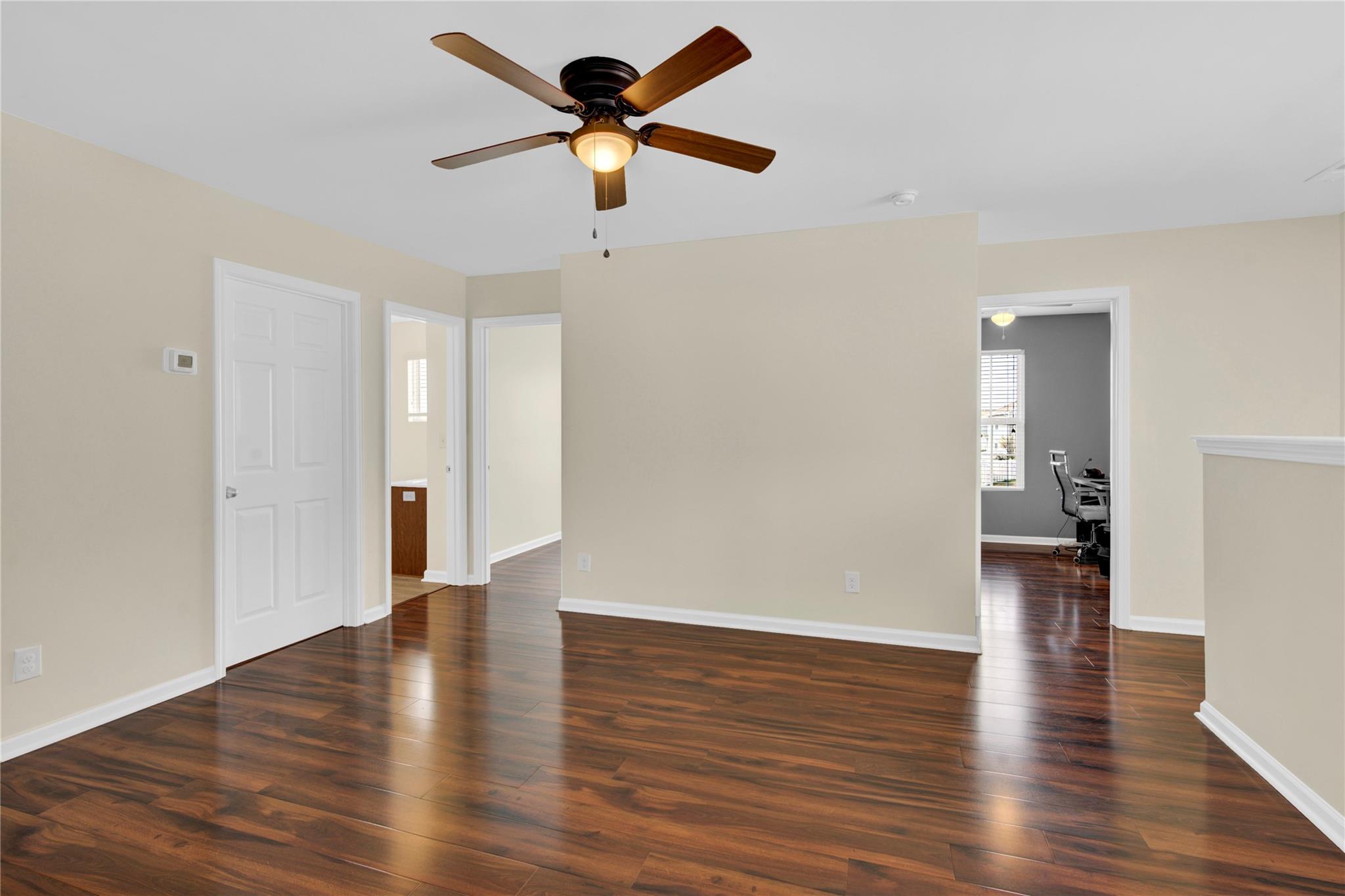 1004 Green Terra Road Indian Trail, NC 28079 - Photo 18 of 40 an empty room with wooden floor and a ceiling fan