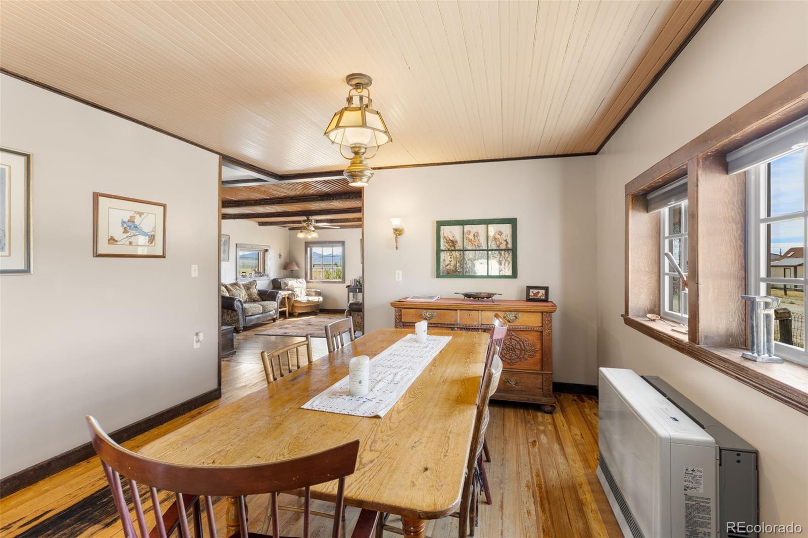 154 Mariposa Street Hartsel, CO 80449 - Photo 13 of 48 a dining room with furniture a chandelier and wooden floor