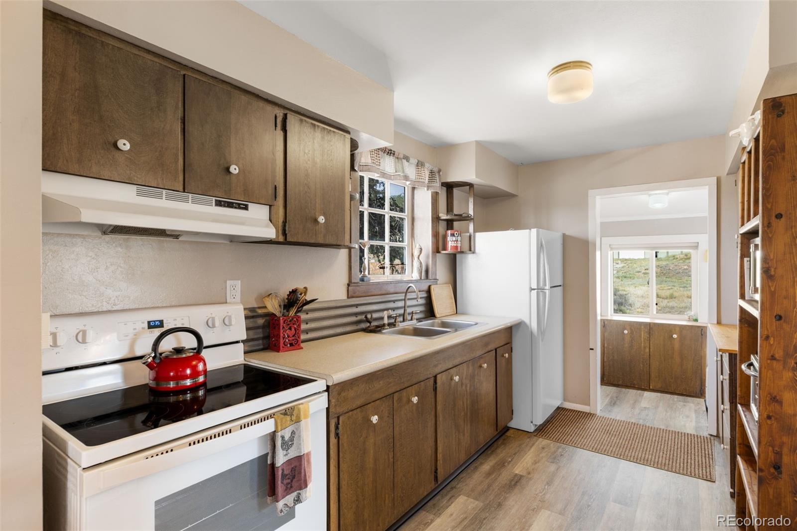 154 Mariposa Street Hartsel, CO 80449 - Photo 15 of 48 a kitchen with a stove a sink and a refrigerator