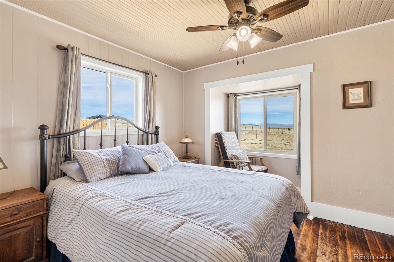 154 Mariposa Street Hartsel, CO 80449 - Photo 21 of 48 a bedroom with a bed and a chandelier