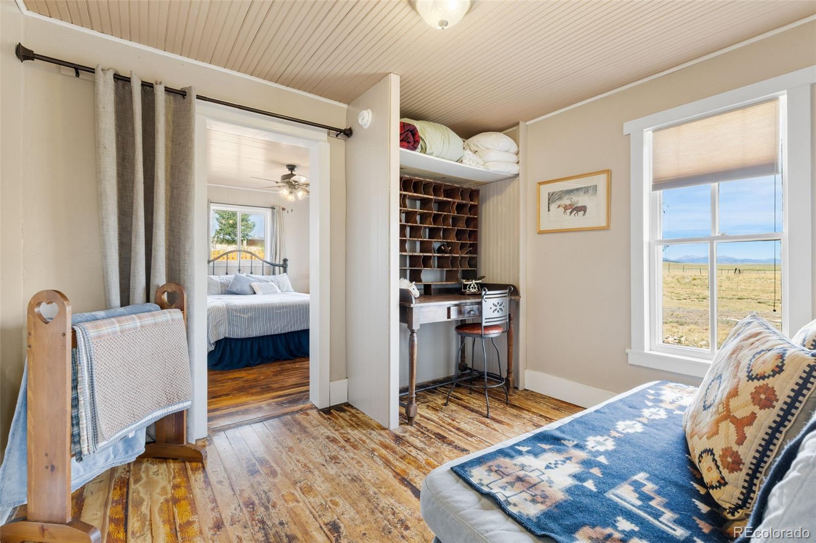154 Mariposa Street Hartsel, CO 80449 - Photo 22 of 48 a bedroom with furniture and a window