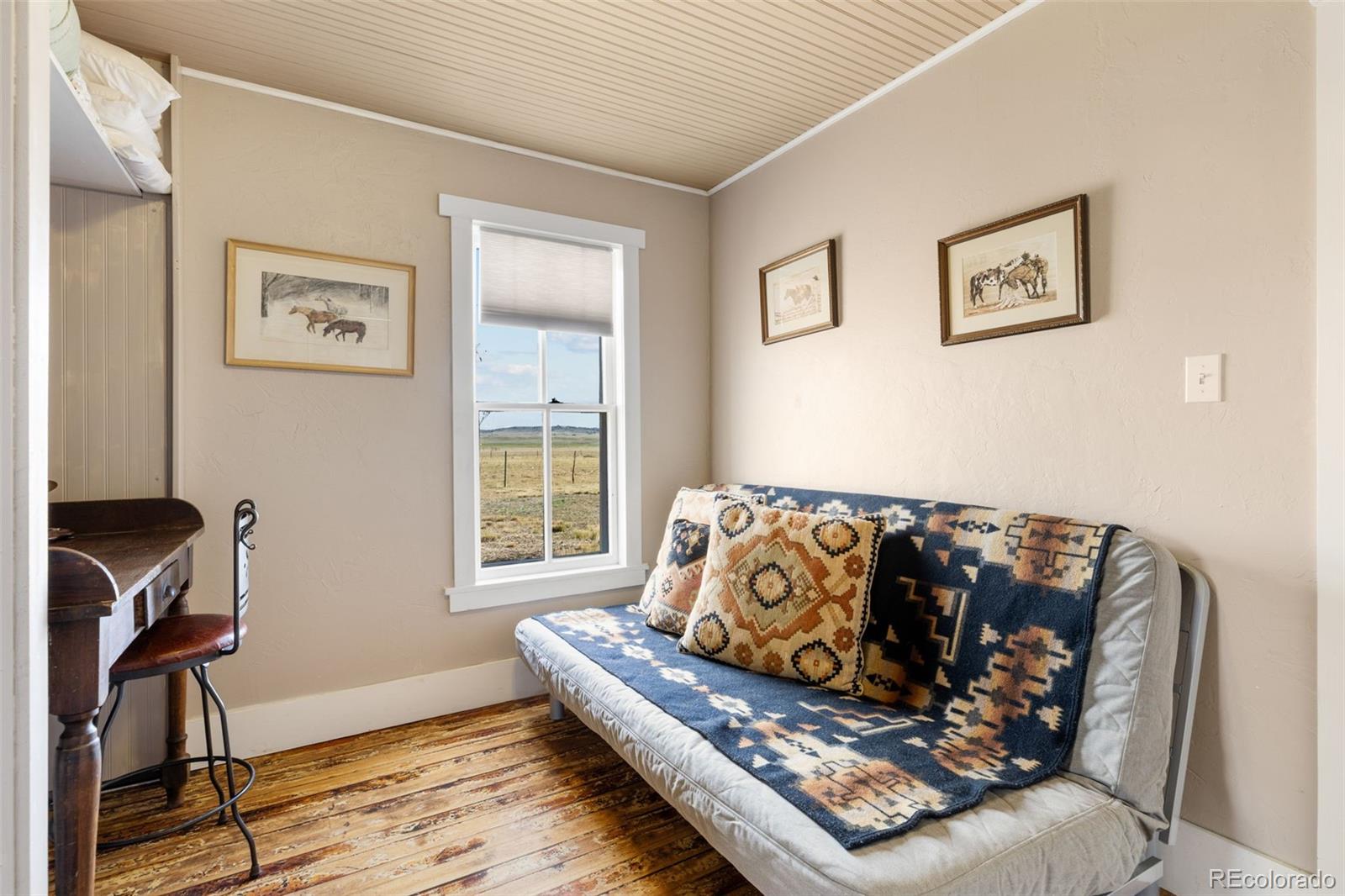 154 Mariposa Street Hartsel, CO 80449 - Photo 23 of 48 a bed sitting in a bedroom next to a window with computer on a table and a window