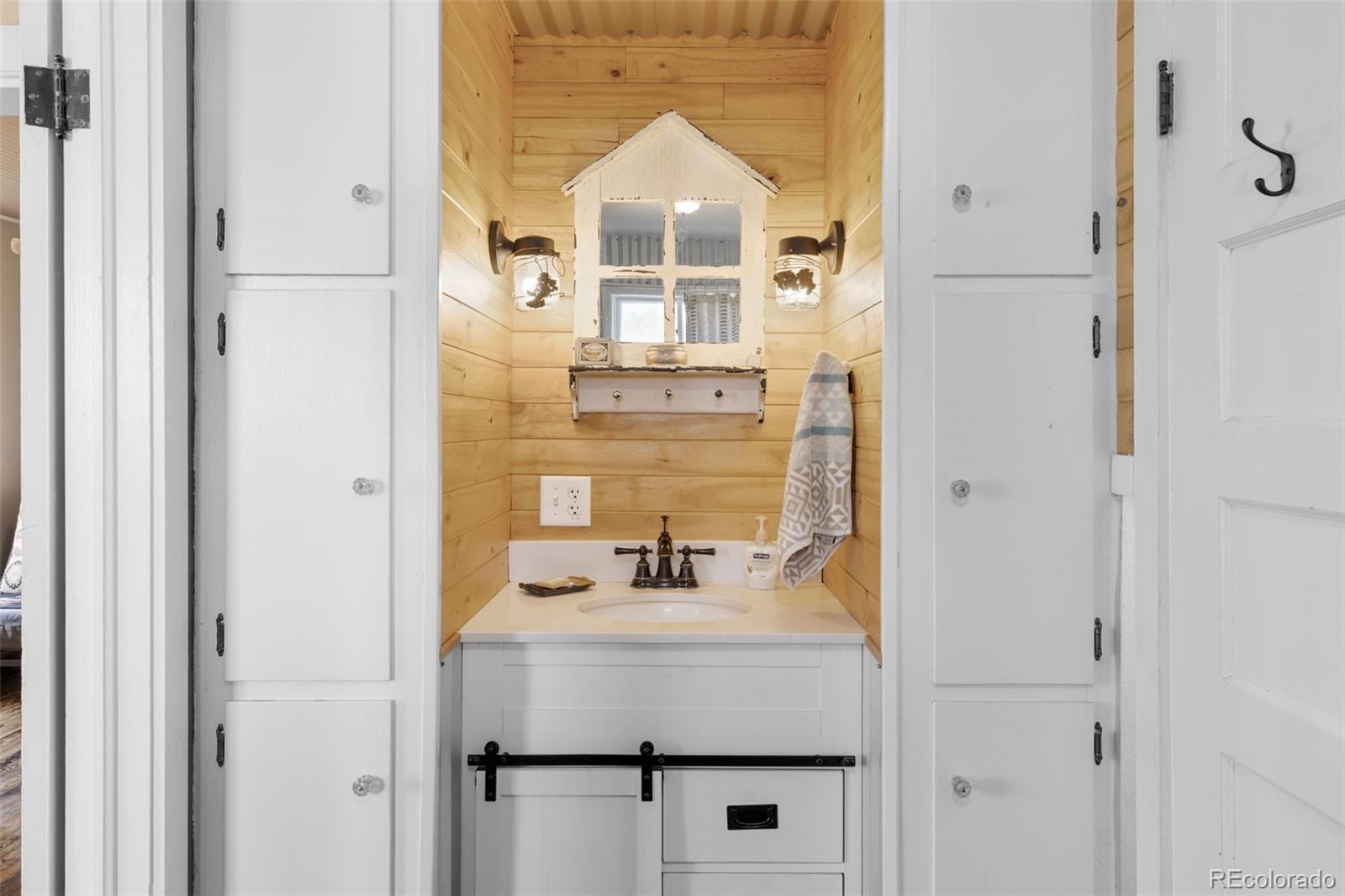 154 Mariposa Street Hartsel, CO 80449 - Photo 26 of 48 a bathroom with a sink and a mirror