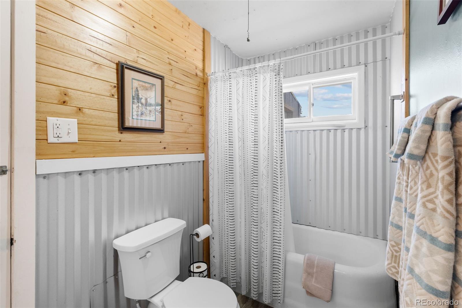 154 Mariposa Street Hartsel, CO 80449 - Photo 27 of 48 a white toilet sitting next to a bathroom sink and tub