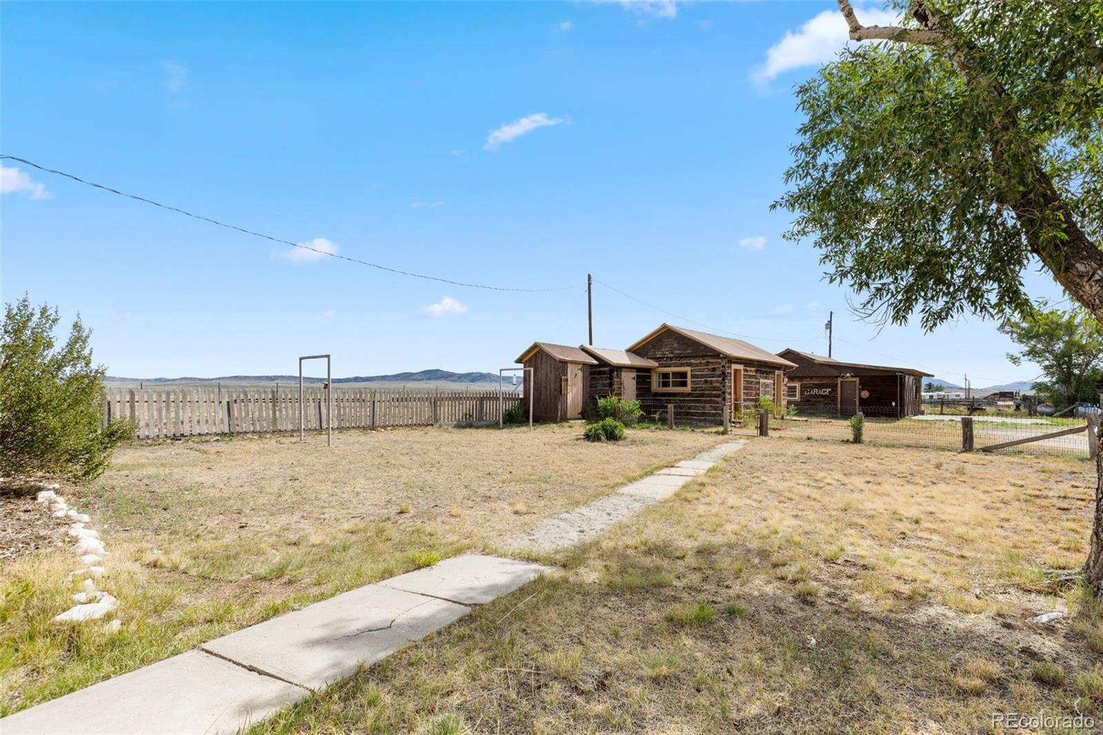 154 Mariposa Street Hartsel, CO 80449 - Photo 33 of 48 a street view with large trees