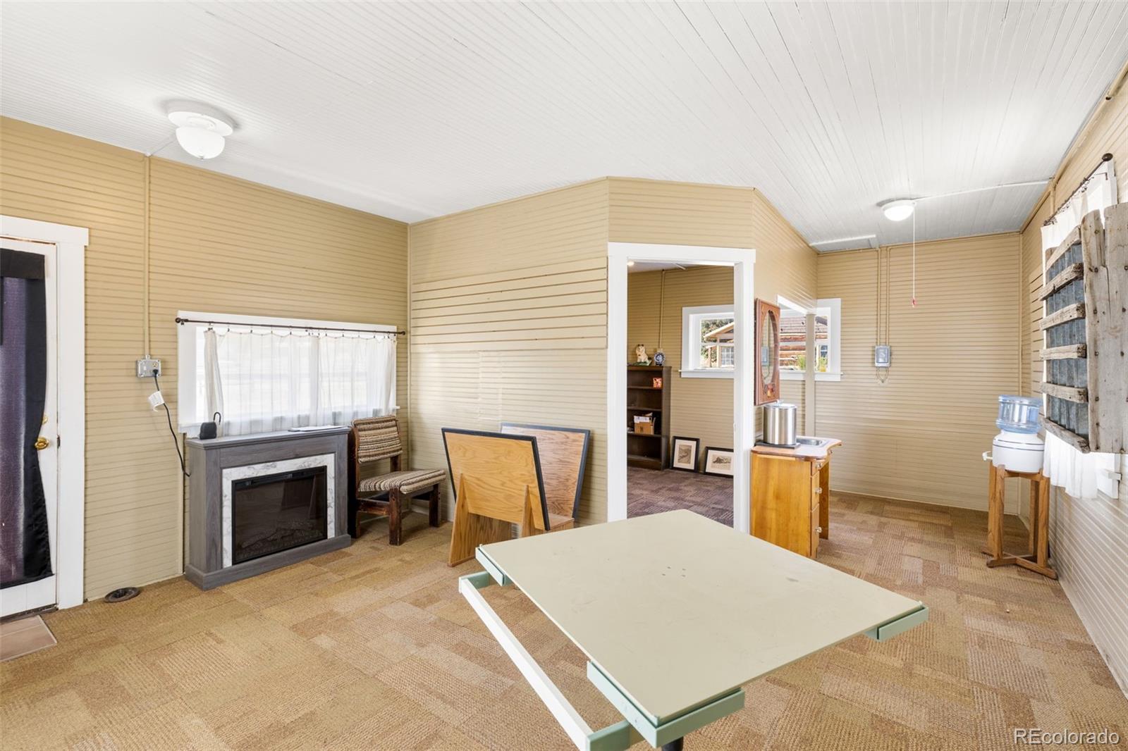 154 Mariposa Street Hartsel, CO 80449 - Photo 39 of 48 a living room with furniture a flat screen tv and kitchen view